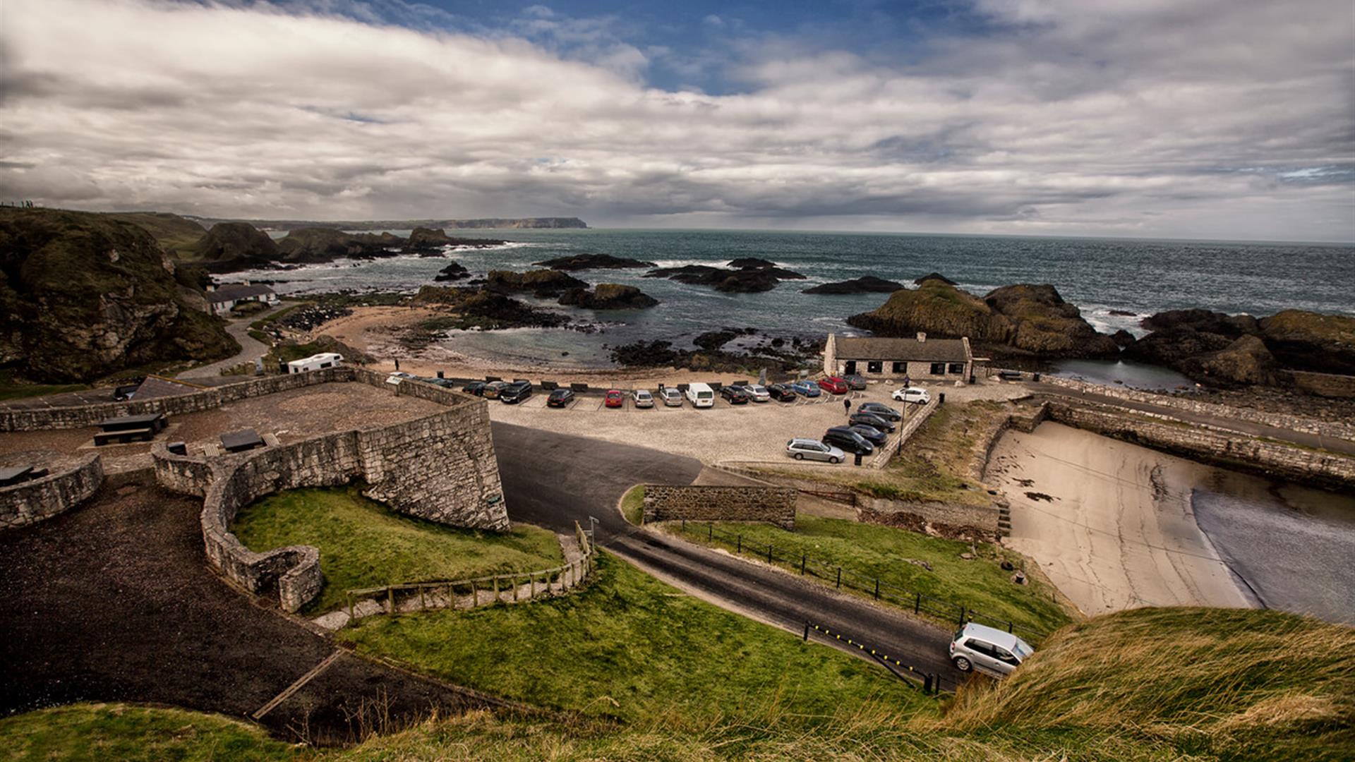 Picturesque Ballintoy Harbour, a small, rocky natural harbour on the Causeway Coast near Ballycastle, with colourful boats and dramatic cliffs, known as a Game of Thrones filming location.